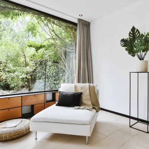 Living room with floor-to-ceiling glass and a sheer curtain
