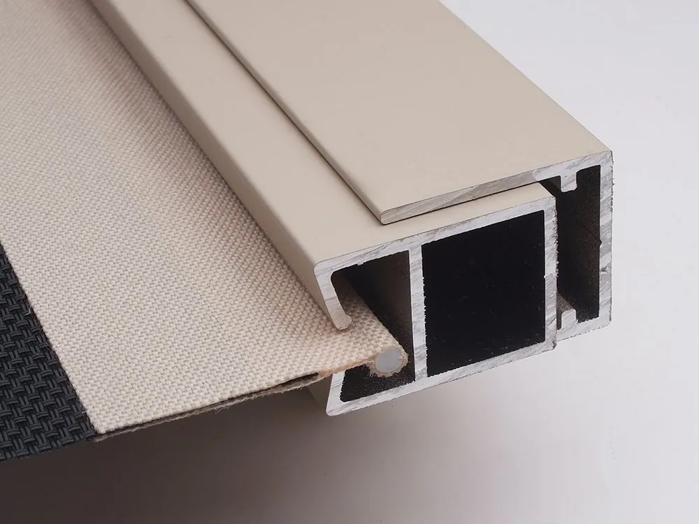 Cutaway of a Ziptrak side channel with the fabric edge captured inside the aluminium profile