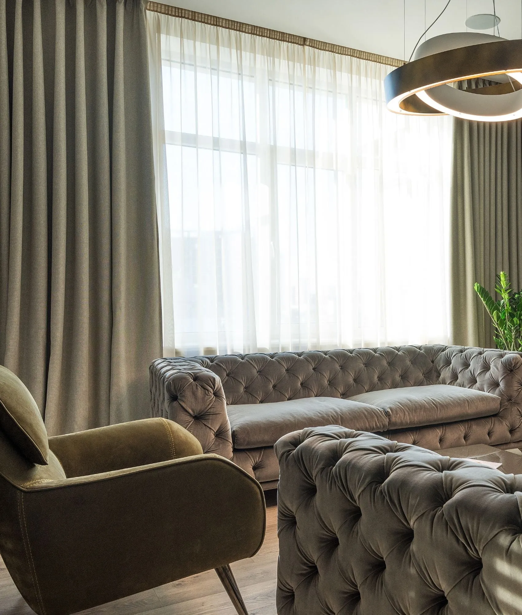 Lounge with tufted sofas and traditional curtains