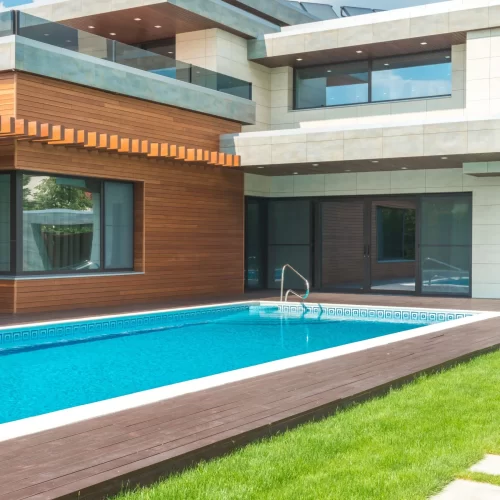 Glass doors beside a home swimming pool
