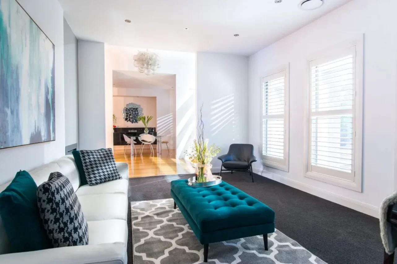 White basswood plantation shutters on two living room windows