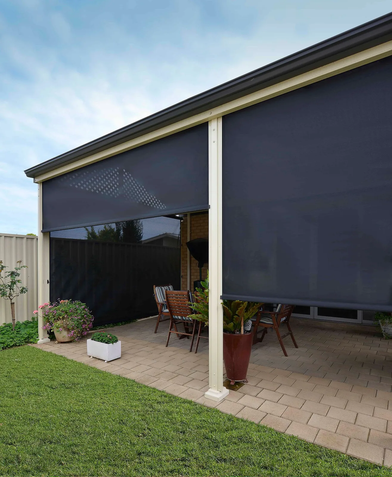 Outdoor blinds lowered over an alfresco patio area