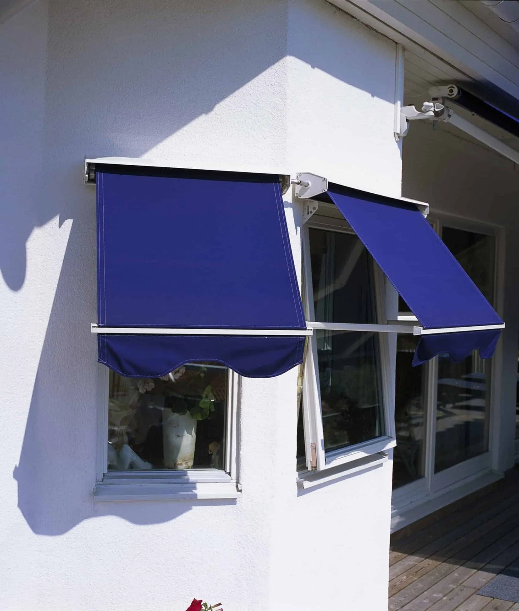 Pivot arm awning over a window