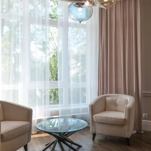 Sitting room with sheer and pink curtains