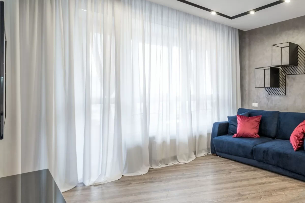 Long sheer curtains pooling on the floor