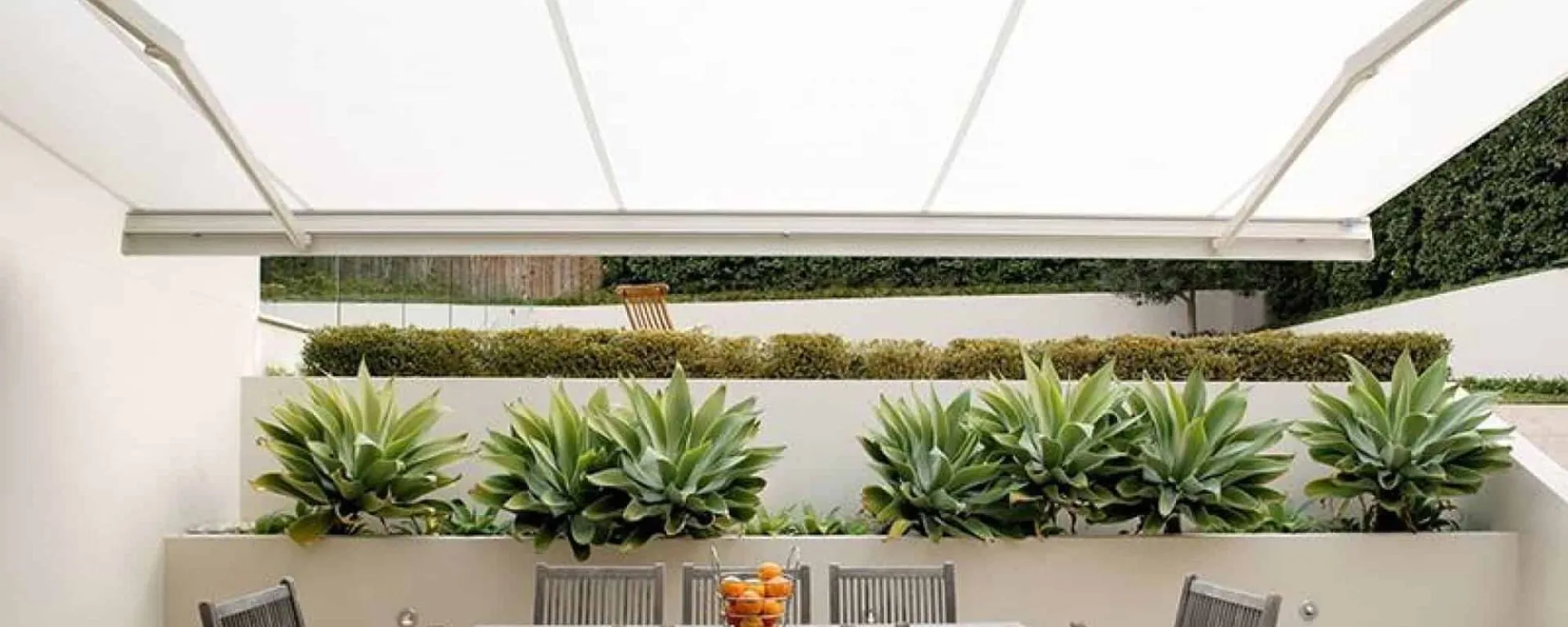 Retractable awning shading an outdoor dining area