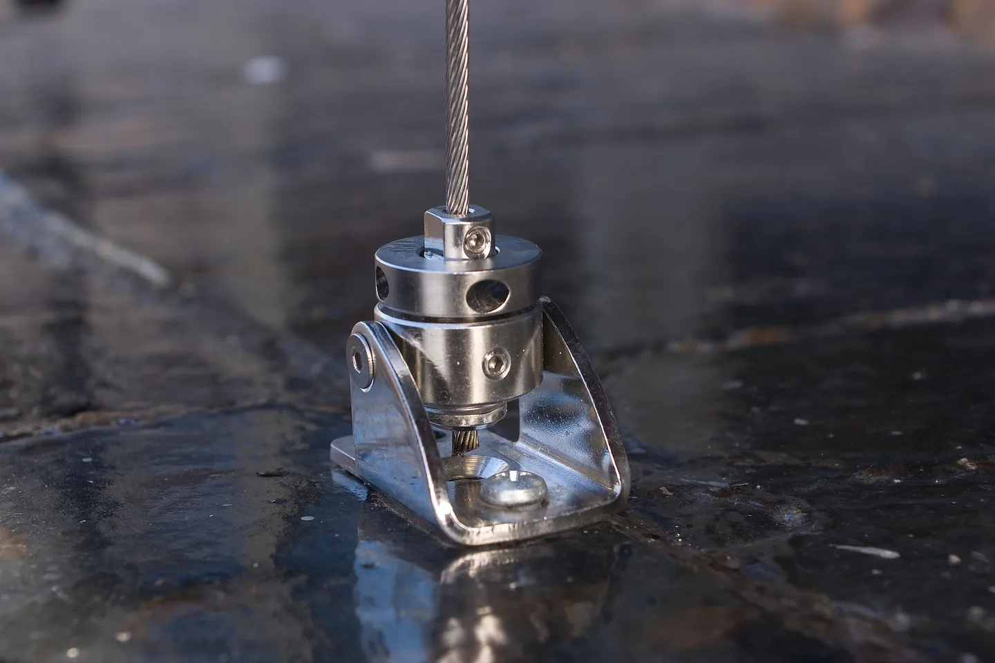 Stainless guide wire tensioner fixed to a stone terrace