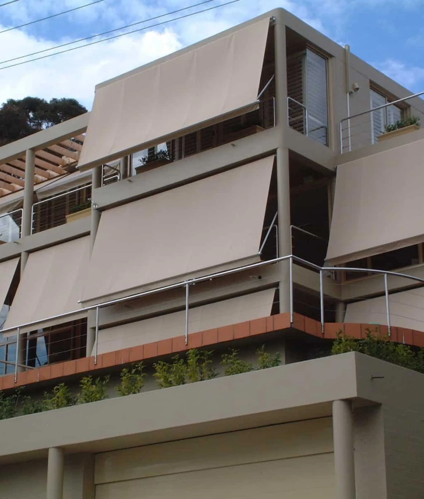 Pivot arm awnings on a brick home