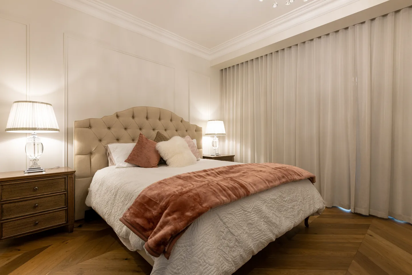 Bedroom with a floor-to-ceiling S-fold curtain drawn along the window wall