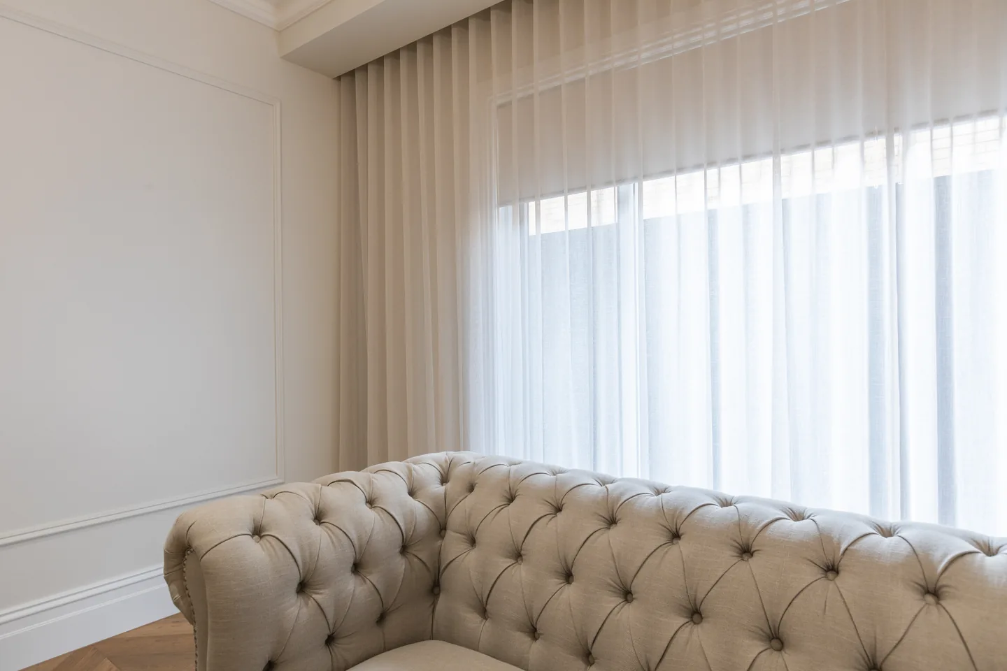 Wide S-fold sheer curtain across a living room window