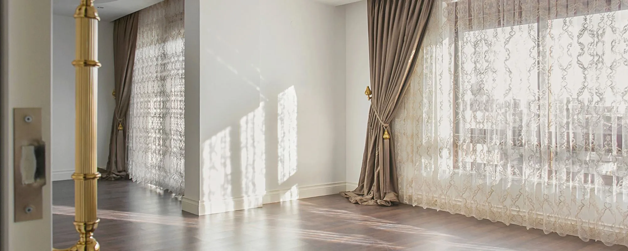 Traditional curtains with tie backs over lace sheers