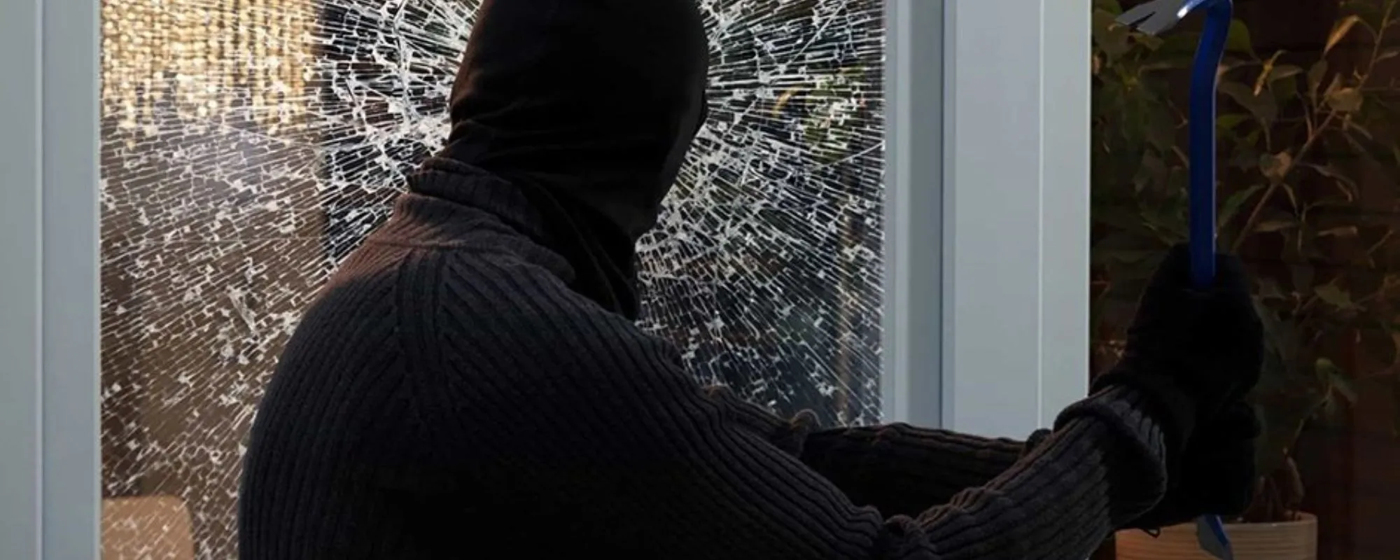 Intruder striking a window protected by security film