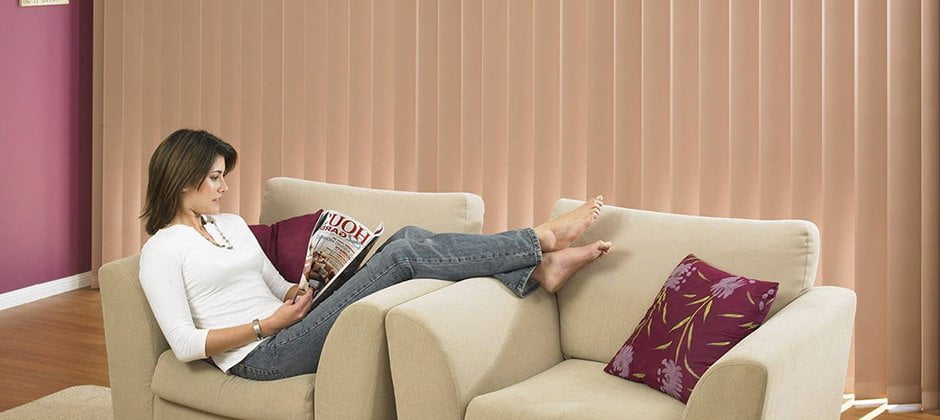 Stanbond SA - Blinds Adelaide - Image of woman in living room with verticle blinds