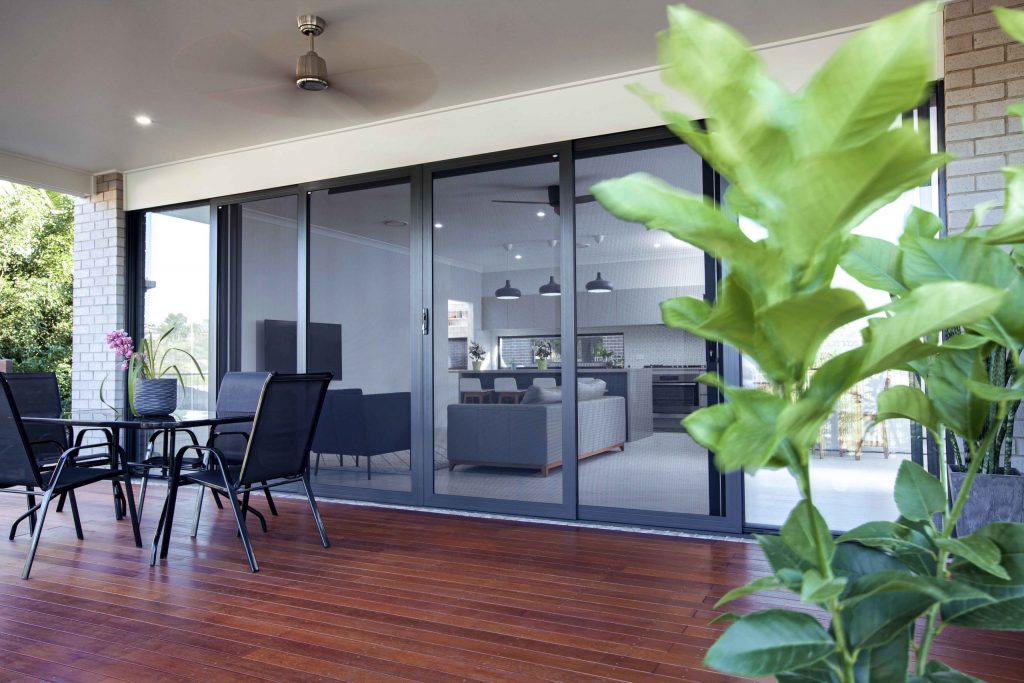 Stan Bond SA - Outdoor Blinds Adelaide - Image of security doors on a wooden floored patio